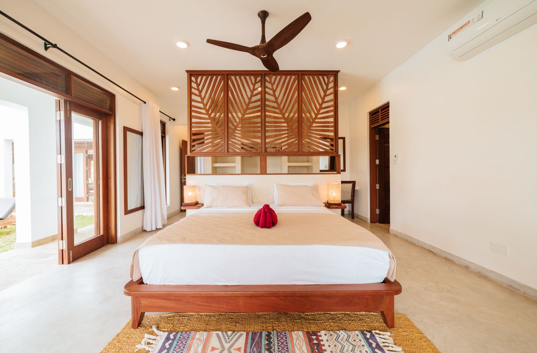 King bedroom with a carved timber headboard